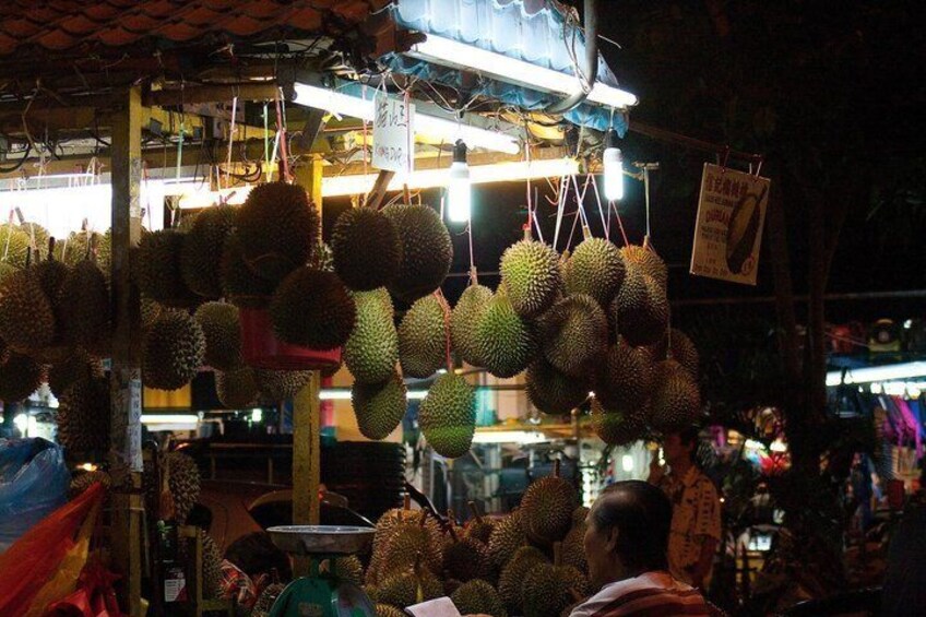 Durians hanging at a market stall. 2