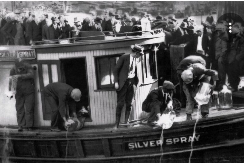 A crowded scene on a boat with people handling silver spray bottles. 3