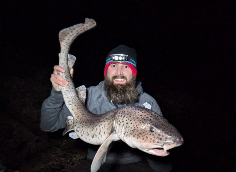 A person holding a large fish. 1