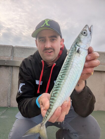 A person holding a fish. 2