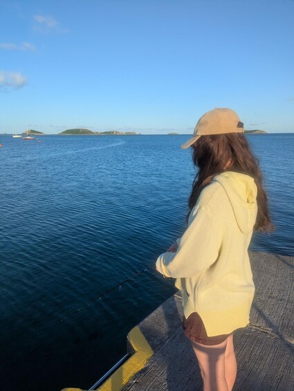 A person fishing by the water. 3