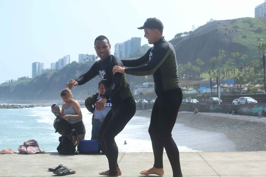 People at a beach with a cityscape in the background. 2
