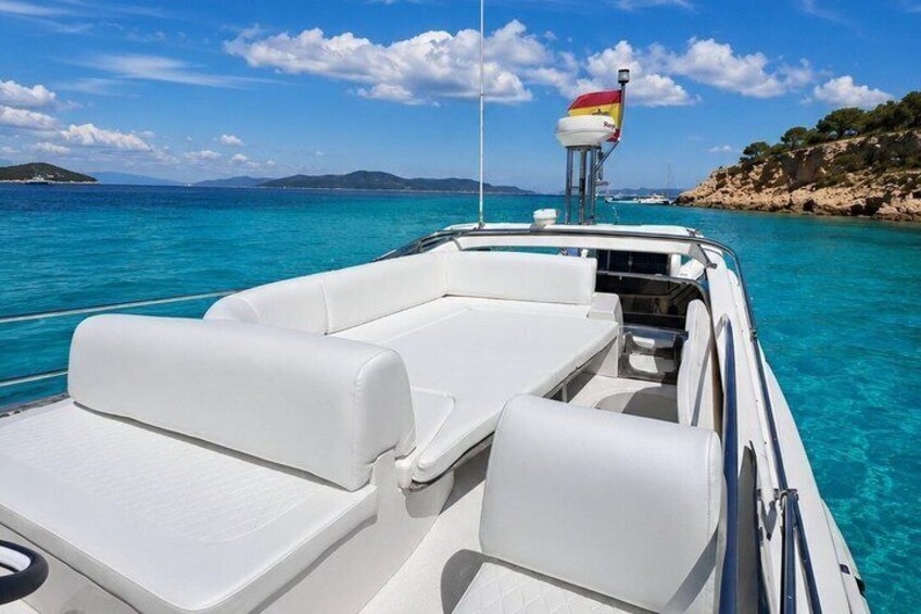 A boat with white seating and a flag on the mast. 4