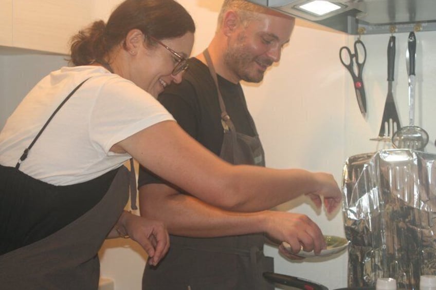 Two people in a kitchen preparing food. 3