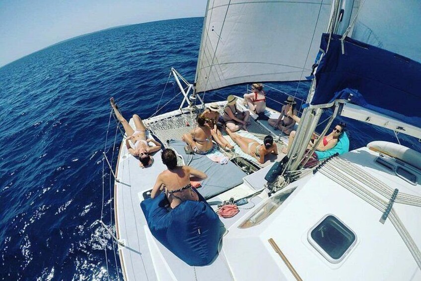 A sailboat with people relaxing on deck. 4
