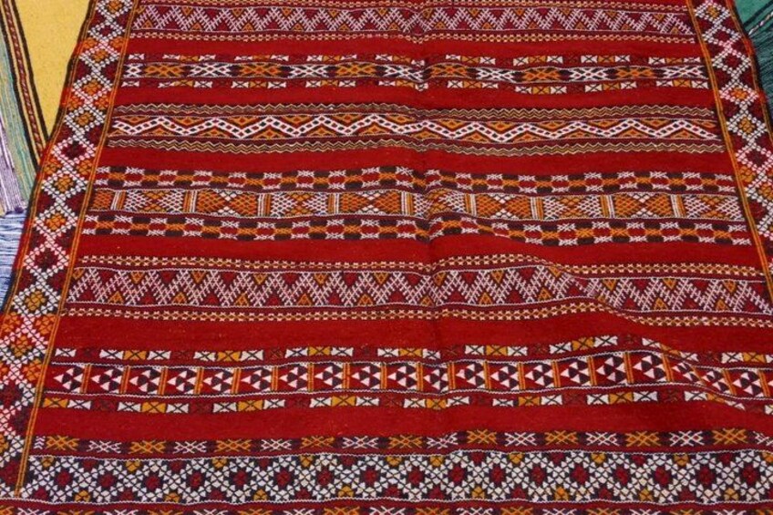 A red patterned carpet with geometric designs. 3