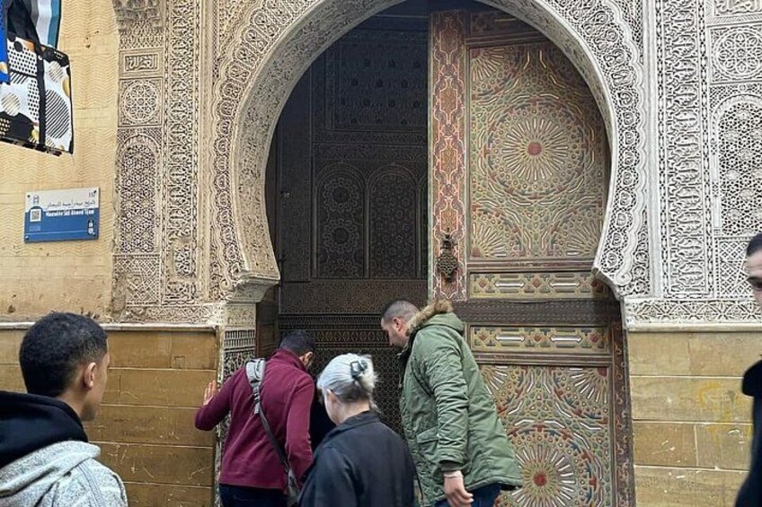 A historic building with ornate carvings and a large, intricately designed door. 3