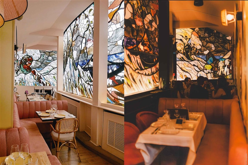 A restaurant with stained glass windows, cushioned seating, and a table set for dining. 1