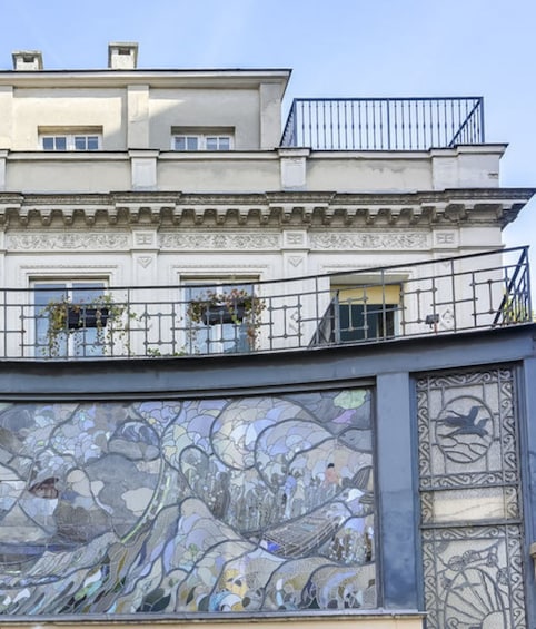 A building with ornate window designs and a balcony. 3