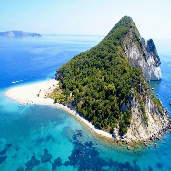 A tropical island with a white sandy beach, dense green forest, and clear blue waters. 3