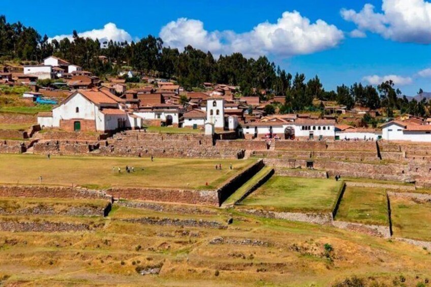 A historical site with ancient ruins, terraced fields, and traditional buildings. 4