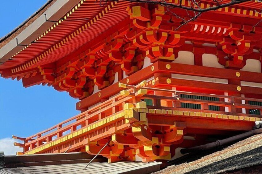 A traditional Japanese building with red and yellow accents and a sloped roof. 3