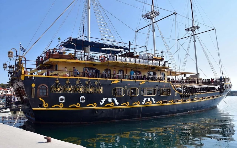 A large, ornately decorated ship docked at a pier. 3