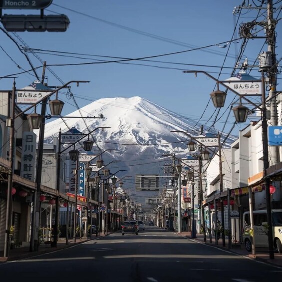 A street with shops and a mountain in the background. 1