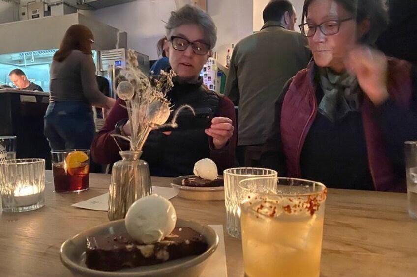 A dessert with ice cream and a drink with a garnish on a table. 3
