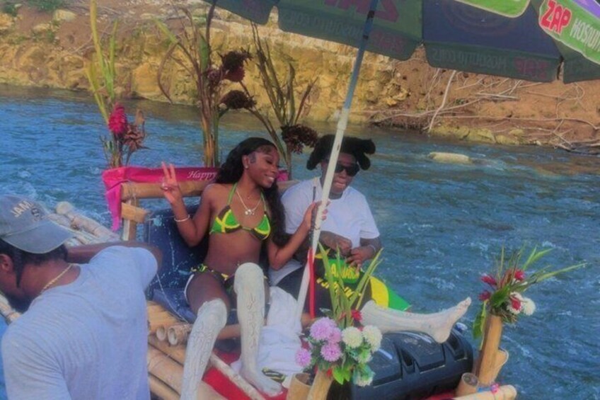 A boat with passengers, decorated with flowers and a paddle. 4