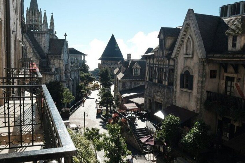 A medieval town with narrow streets, historic buildings, and a prominent church steeple. 5