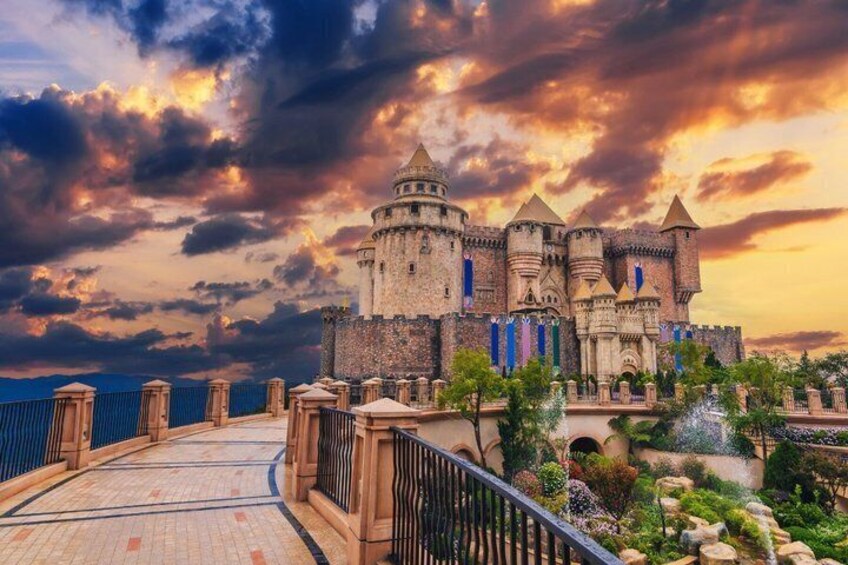 A castle with a large central tower, surrounded by a moat and a bridge. 3