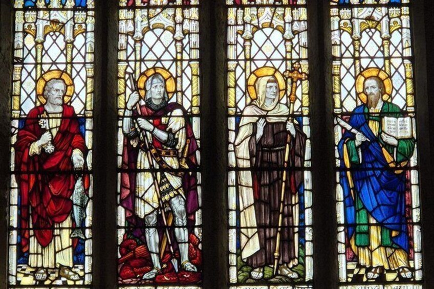 A stained glass window with religious figures. 2