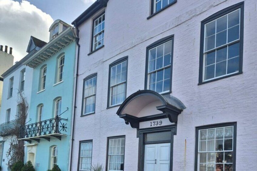 A row of historic buildings with a prominent number '1739' on the facade. 4