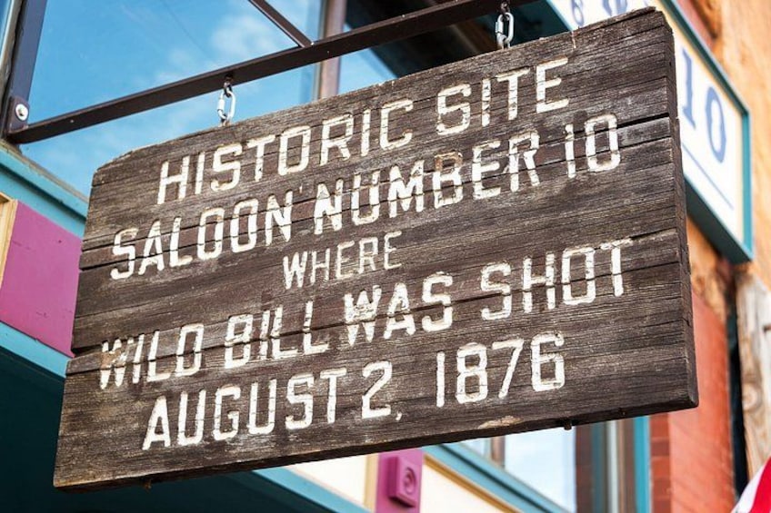 A wooden sign with historical information. 5