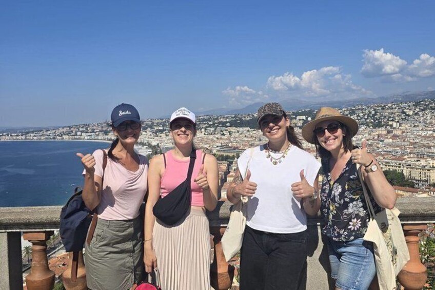 Four people posing with a cityscape and water in the background. 5