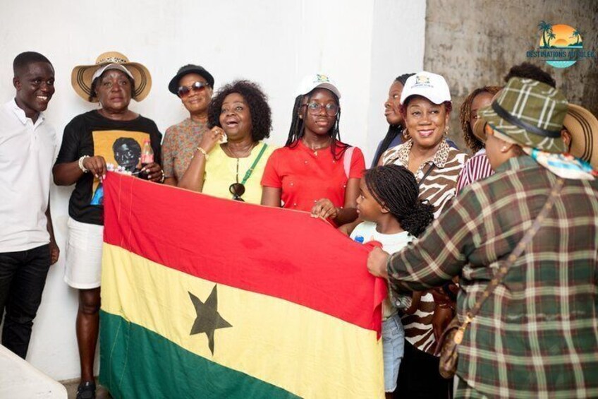 A group of people holding a flag, with a logo in the top right corner. 4