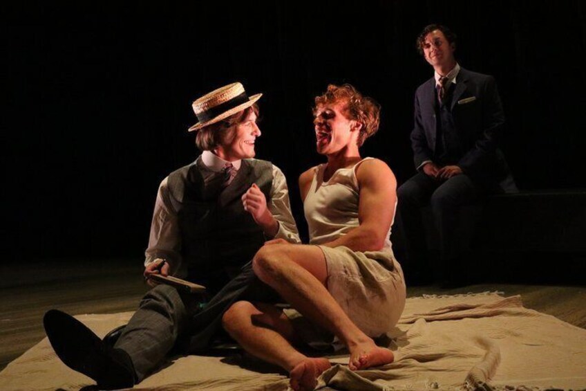 Three people on a stage with a dark background. 3