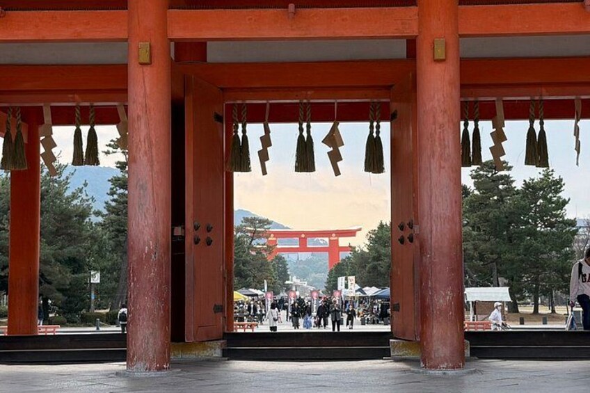 A traditional Japanese torii gate with red pillars and a red torii in the background. 2
