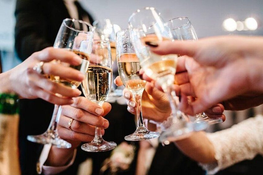 A group of people toasting with champagne glasses. 2