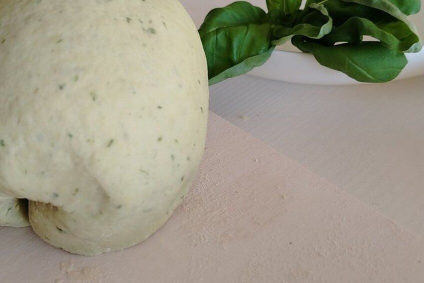 A large, round, white object with green leaves, possibly a squash, on a light-colored surface. 4