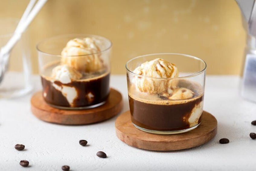 Two glasses of iced coffee with ice cream on wooden coasters. 2