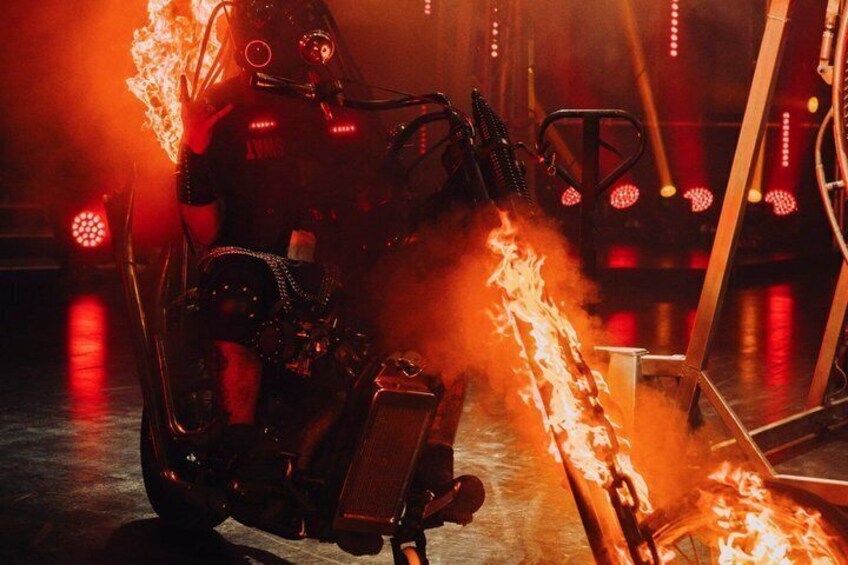 A person in a mechanical suit with flames emanating from their helmet. 4