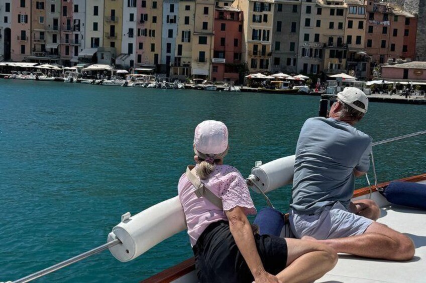 Two people on a boat with a cityscape in the background. 5