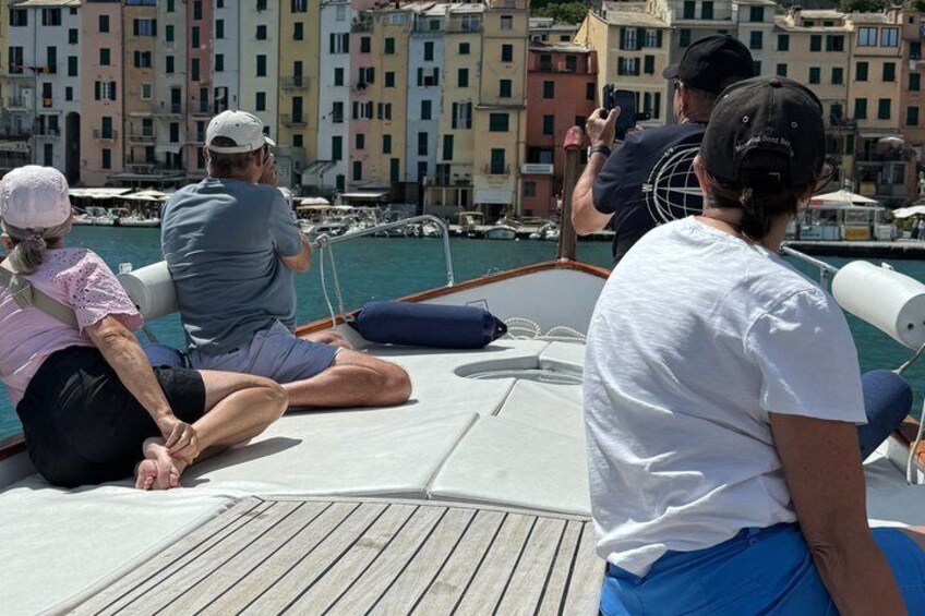 People on a boat with a cityscape in the background. 4