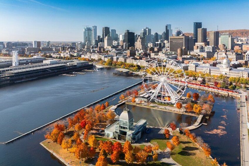 A cityscape with a river, a Ferris wheel, autumn trees, and modern buildings. 3