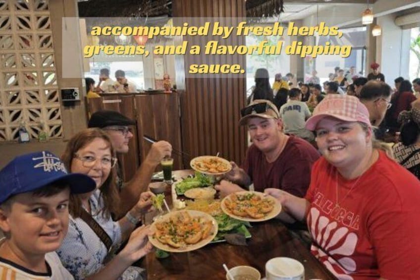 A group of people dining at a restaurant with a wooden interior and a view of the outdoors. 1