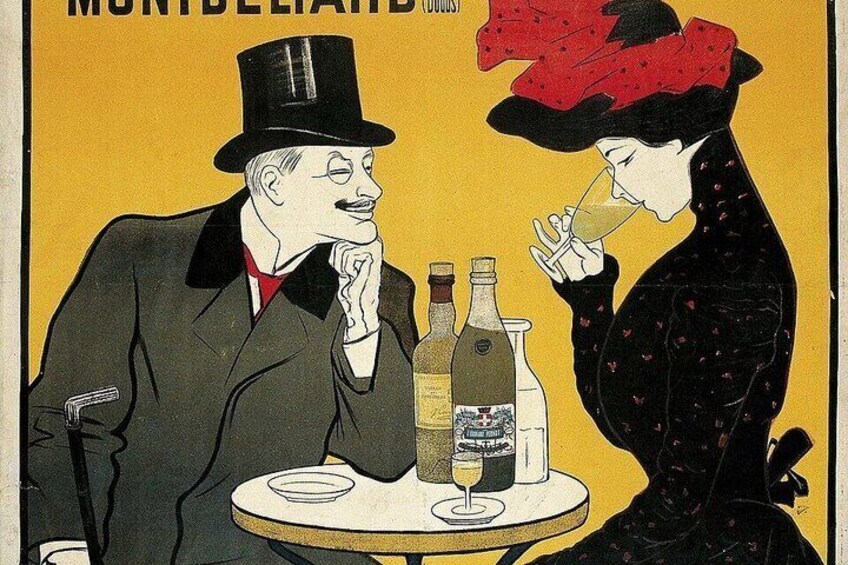 A man and a woman sitting at a table with bottles and glasses, suggesting a social gathering. 4