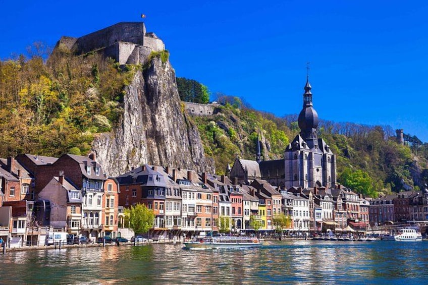 A town with historic buildings, a church, and a castle on a hill. 2