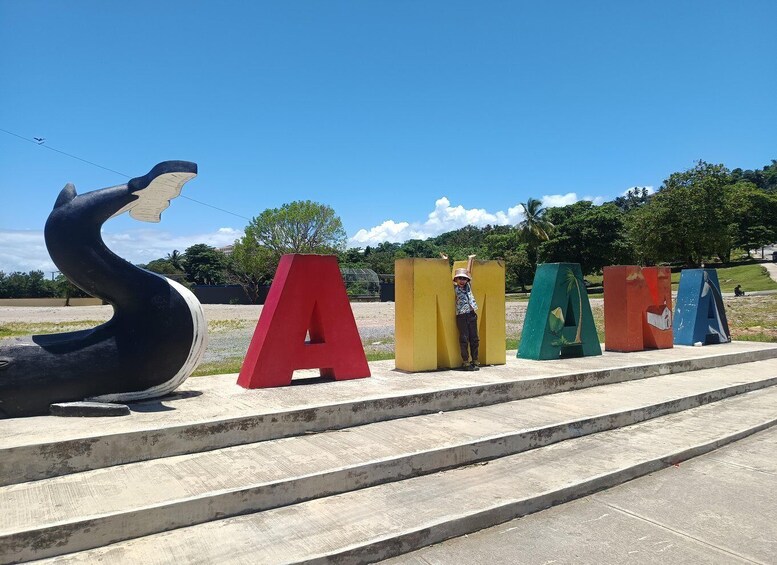 A sculpture of a swan and colorful letter-shaped structures. 4