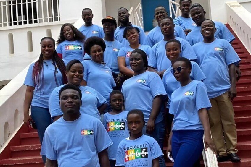 A group of people on a staircase wearing blue t-shirts with a logo. 5