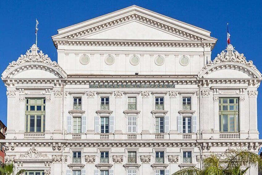 A classical building with ornate architectural details, including columns and decorative moldings. 5