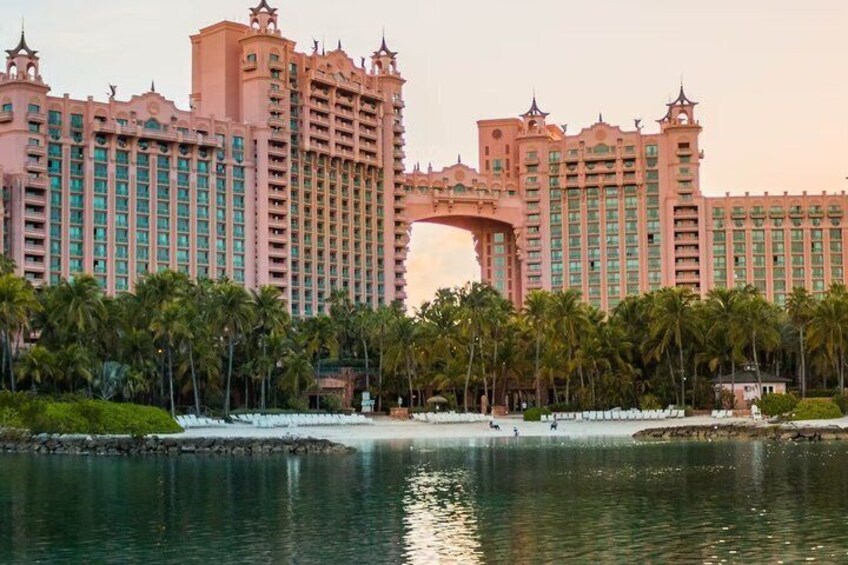 A large hotel with a distinctive archway and palm trees. 5