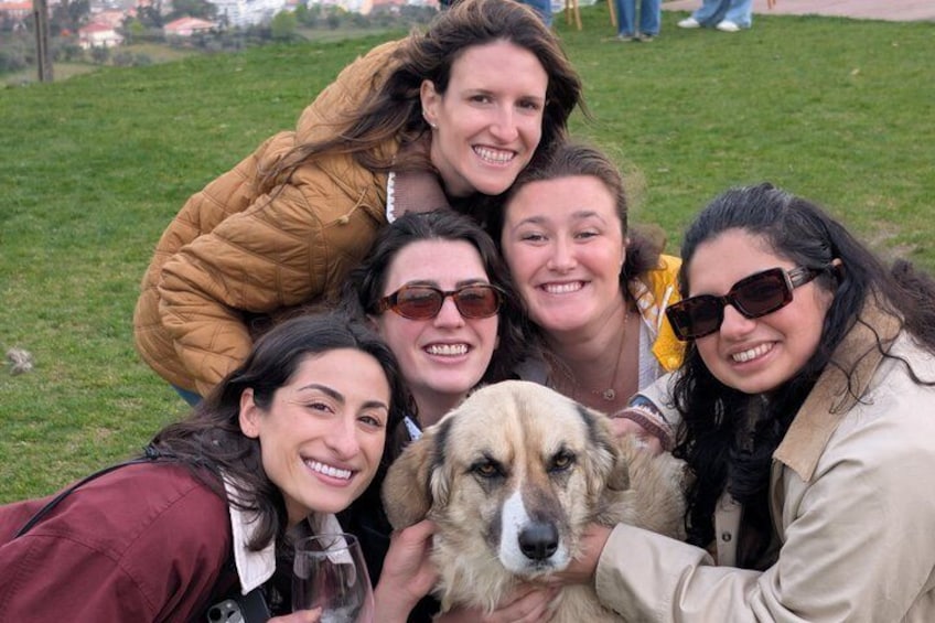 A group of people outdoors with a dog. 4