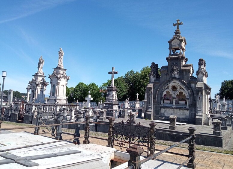 A cemetery with ornate gravestones and a prominent church structure. 4