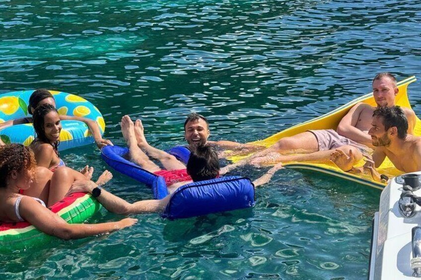 People floating on water with inflatable rings. 3