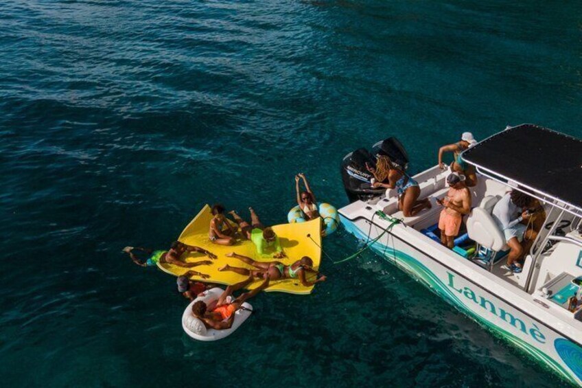 A boat with people on a yellow raft and a smaller boat named 'Lanme' in the water. 4