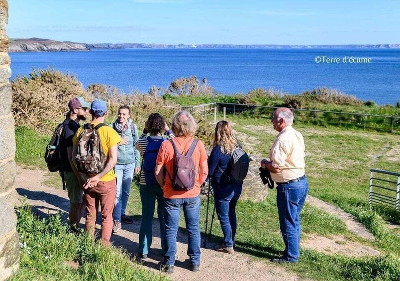 A group of hikers on a coastal trail with a view of the sea. 2