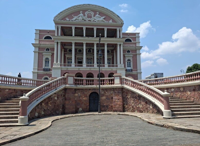 A classical building with a central dome, columns, and a grand staircase. 1