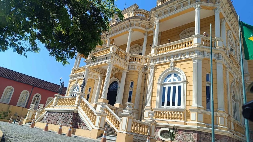 A historic building with ornate balconies, columns, and a clock. 3